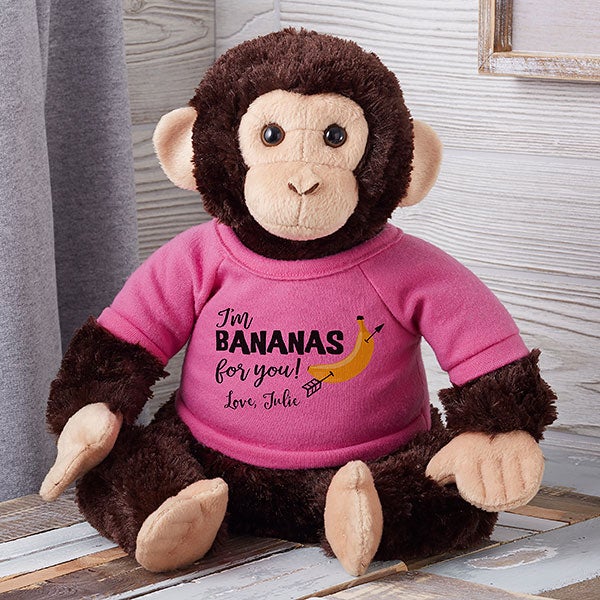 stuffed yellow and black monkey with banana